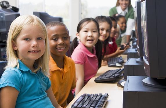 Children sitting in front of computers