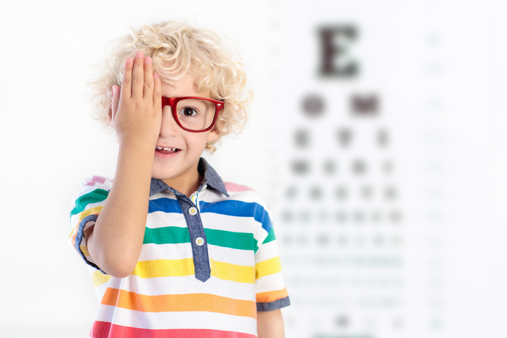 Child at eye sight test. Kid at optical shop. Eyewear for kids.