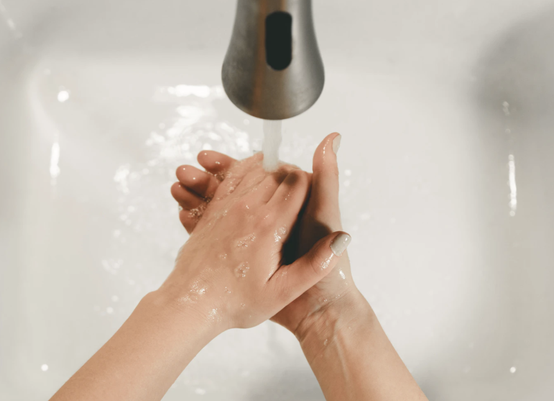 Hands washing in a sink